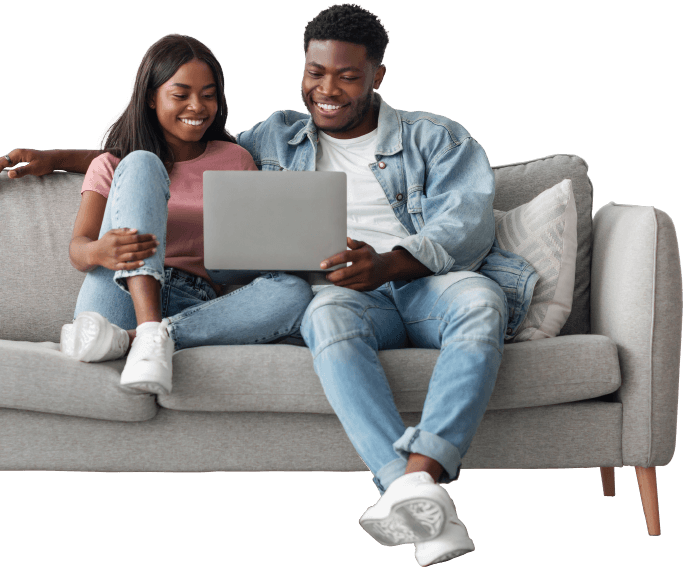 Couple using a laptop to research boiler installation options at home in Newport